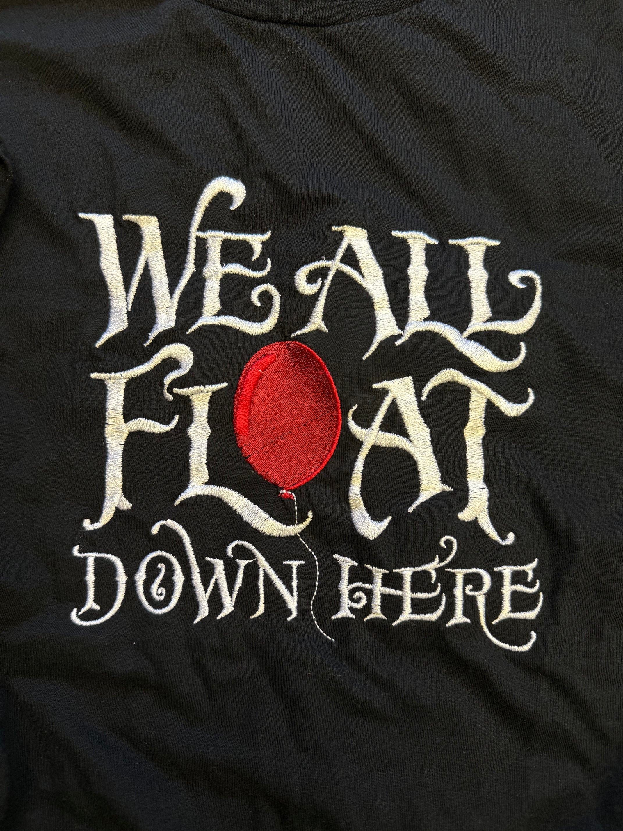 We All Float Tee