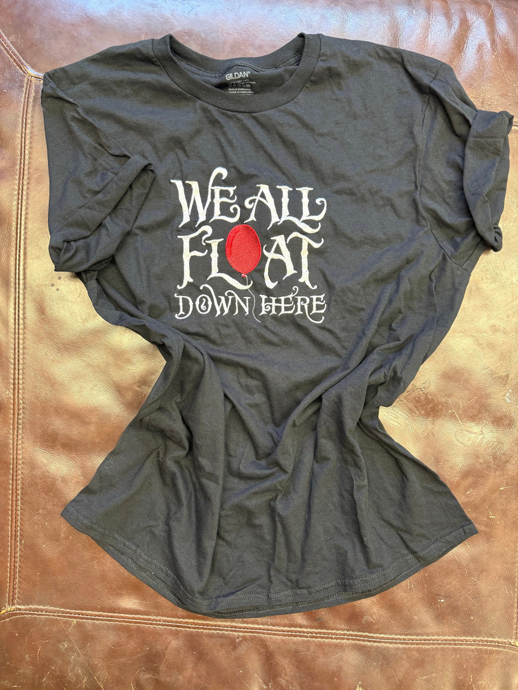 We All Float Tee